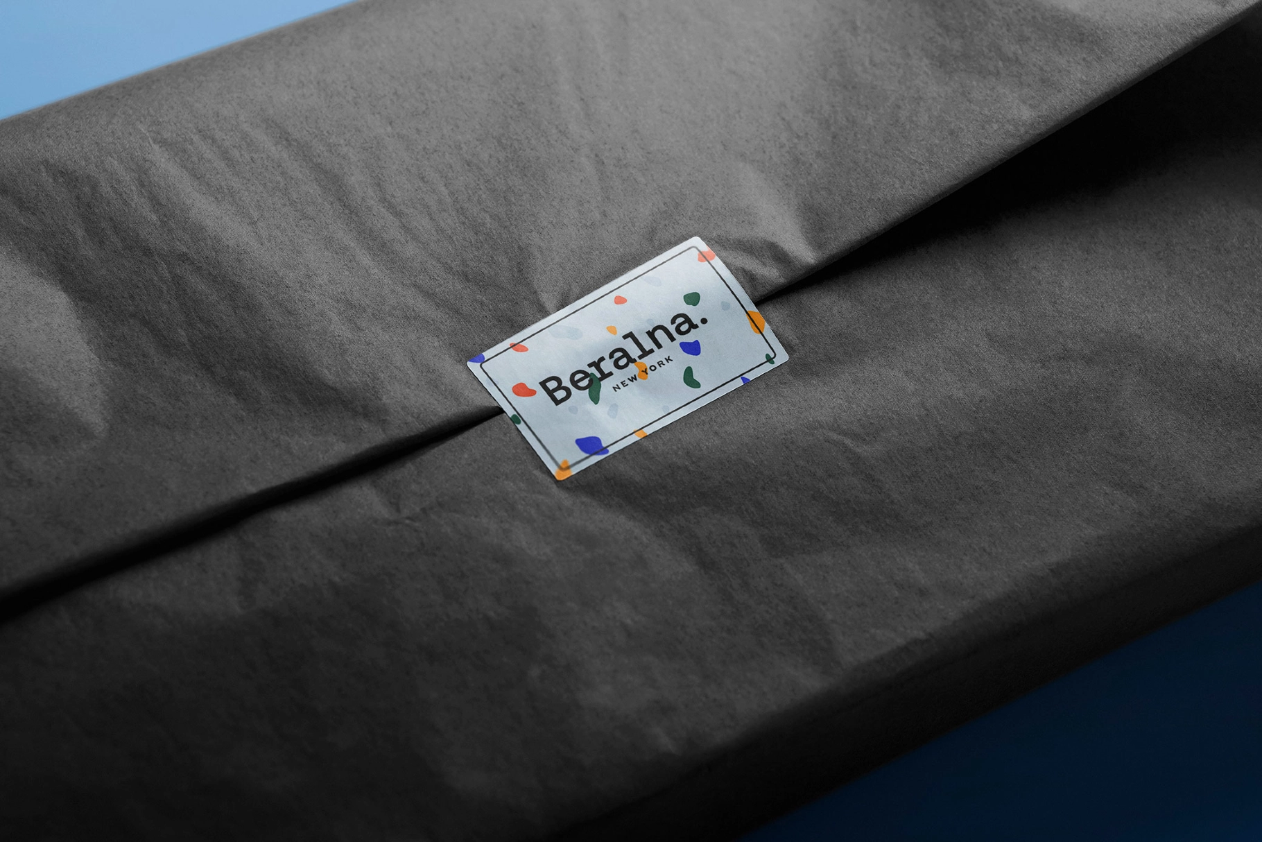 Sticker Mockup Over Folded Tissue Wrap