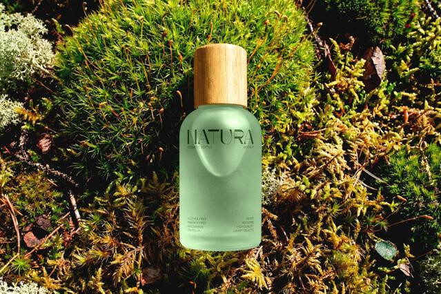 Frosted Cosmetic Bottle Mockup in Moss