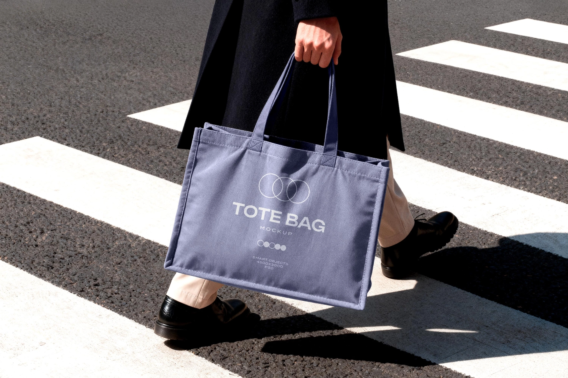 Tote Bag Mockup Held in Motion on Crosswalk
