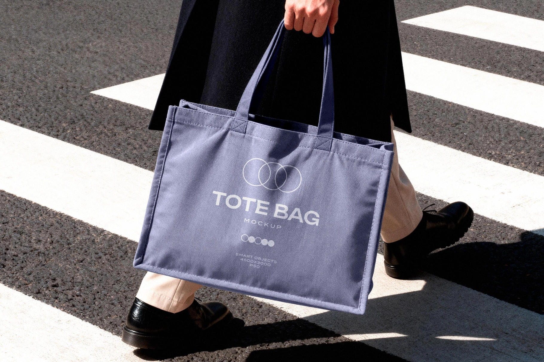 Tote Bag Mockup Held in Motion on Crosswalk