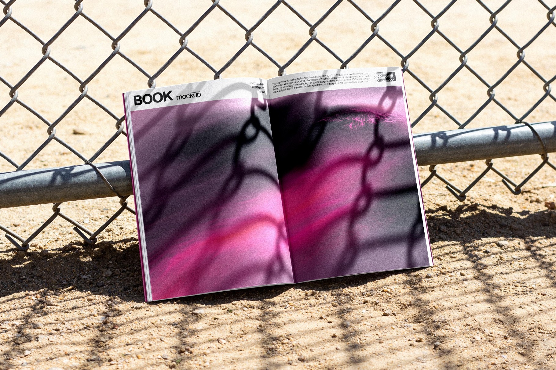 Open Book Mockup Against a Fence